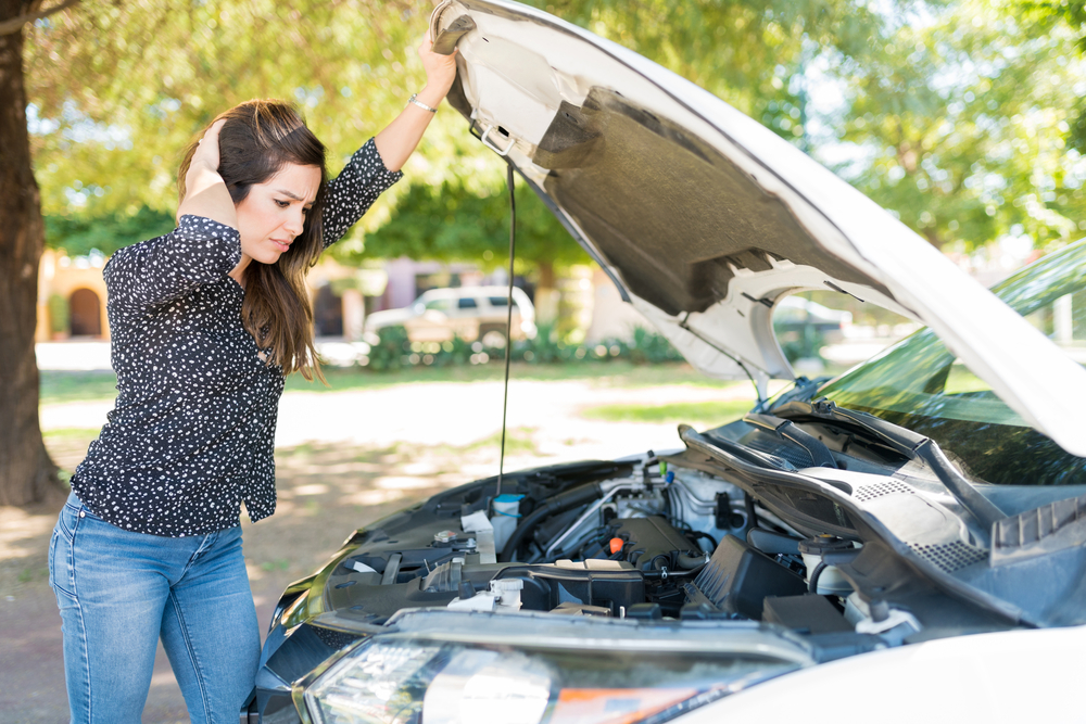 Woman In Despair Looking At Broken Car need a mobile auto mechanic in San Diego